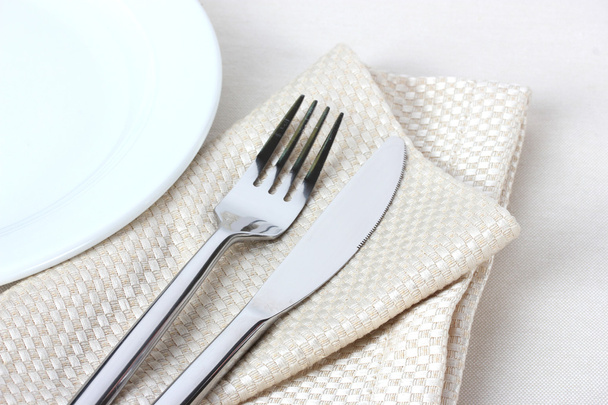 Fork, knife on napkin and plate isolated on white - Φωτογραφία, εικόνα