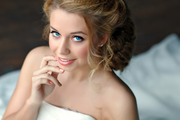 Portrait of a girl with thick blond hair and blue eyes in a  white dress, close-up - Foto, Imagen