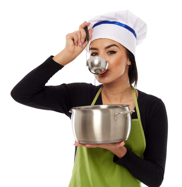 Beautiful woman cook tasting soup - Zdjęcie, obraz