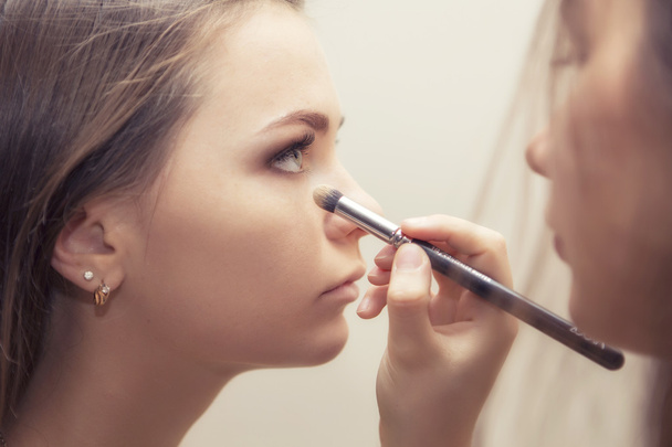Brunette make up artist woman applying make up for a brunette br - Photo, Image