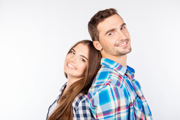 Young smiling couple standing back-to-back - Фото, зображення