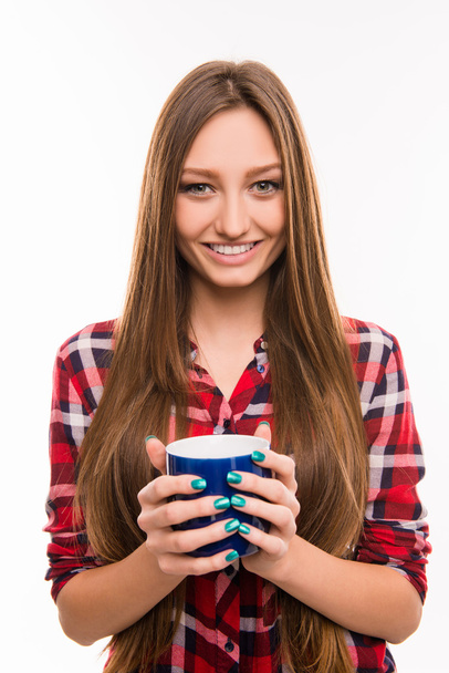 A portrait of cute girl smiling with a cup in her hands - Foto, Bild