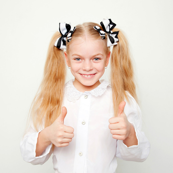 Pupil school child showing thumbs up - Foto, afbeelding