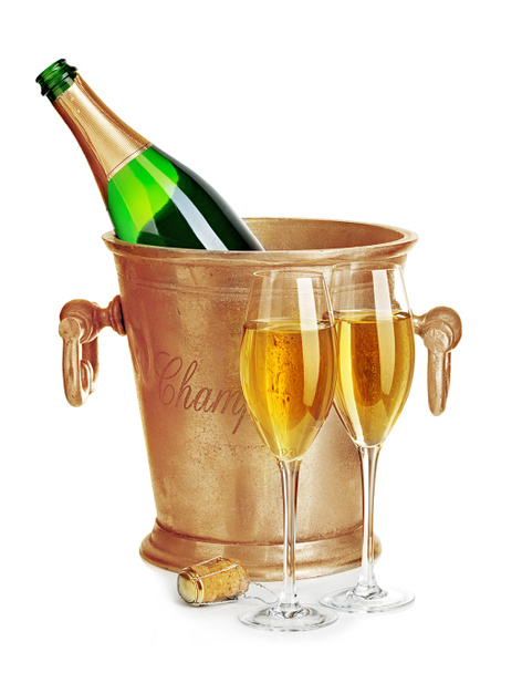 Champagne bottle in golden ice bucket with glasses of champagne close-up isolated on a white background. Festive still life. - Photo, Image