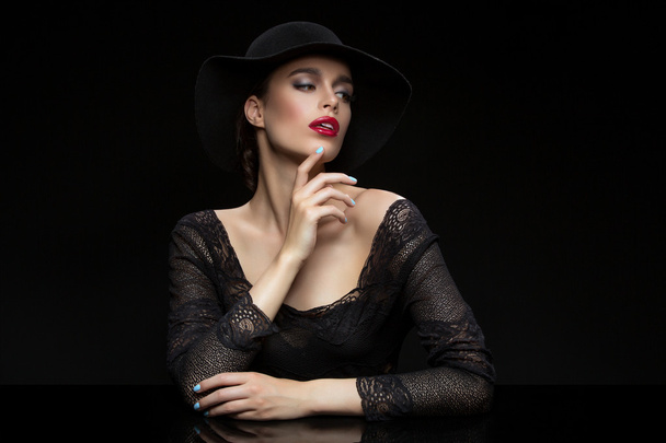 Beautiful girl with red llips in black hat - Photo, Image