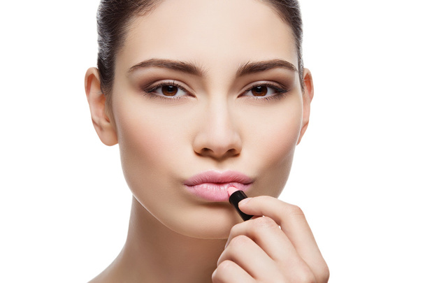 Beautiful girl applying pink lipstick - Zdjęcie, obraz