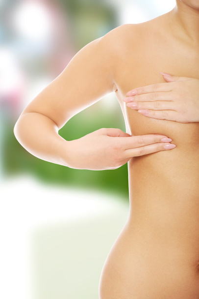 Woman examining breast - Fotografie, Obrázek