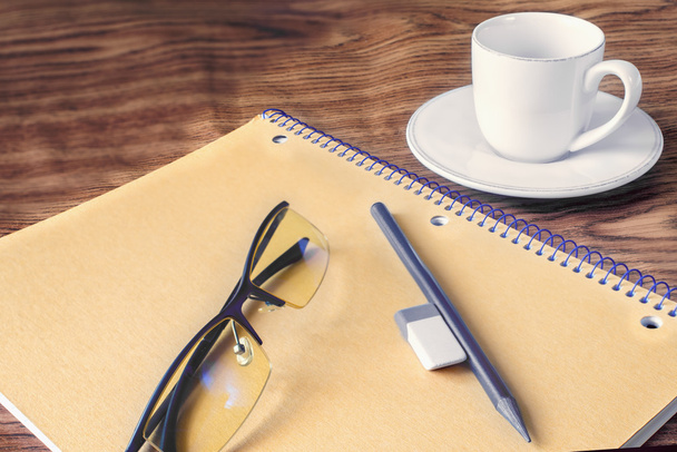 pencil and notebook, cup of coffee, glasses, Eraser, on a wooden - Foto, immagini