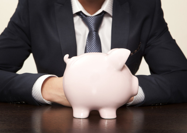 Businessman with pink piggy bank - Foto, immagini