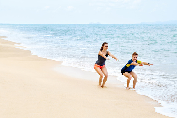 Fitness Exercises. Healthy Couple Squatting, Exercising On Beach - Fotoğraf, Görsel