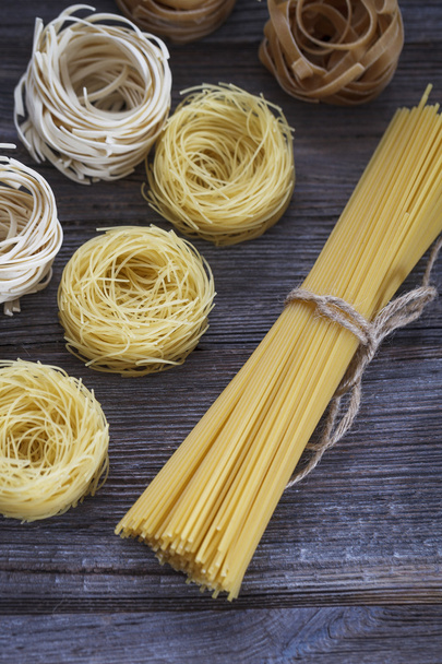 A set of raw pasta on a wooden table - Zdjęcie, obraz