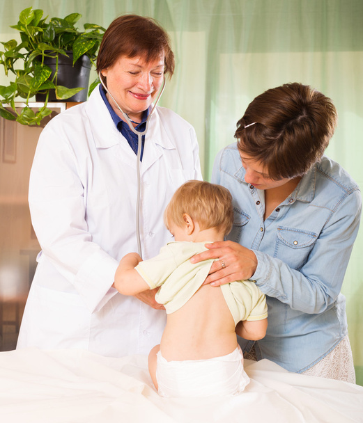 pediatrician doctor examining baby at clinic - Photo, Image