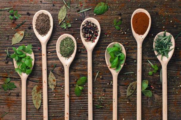 Various spices on wooden spoons - Фото, изображение