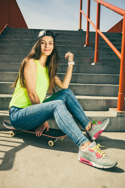 girl sitting on skateboard - Фото, зображення