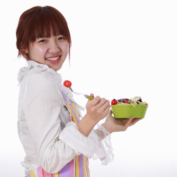 Una mujer china con vegetales aislados en blanco
. - Foto, Imagen