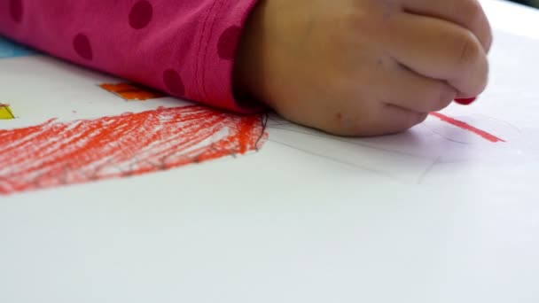 Close up  of a child painting with pastels at school - Materiał filmowy, wideo