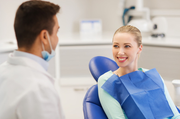 happy male dentist with woman patient at clinic - Φωτογραφία, εικόνα
