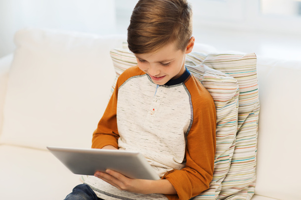 smiling boy with tablet computer at home - Valokuva, kuva