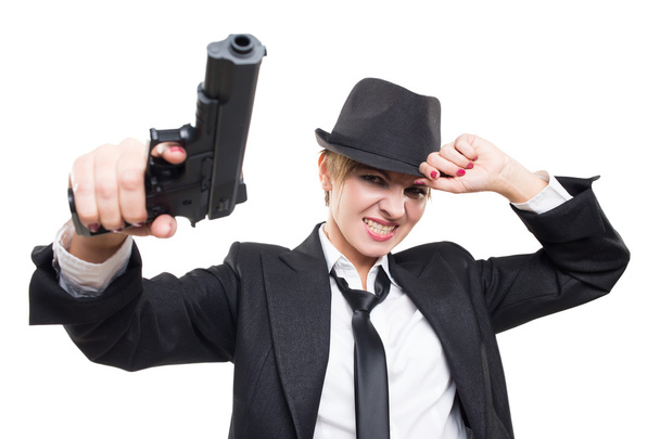 beautiful girl gangster holding a gun. Classic suit and hat. isolated on white - Foto, Imagen