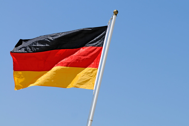 német zászló a szélben - Fotó, kép