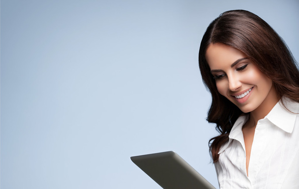 businesswoman using no-name tablet pc, over grey - Φωτογραφία, εικόνα