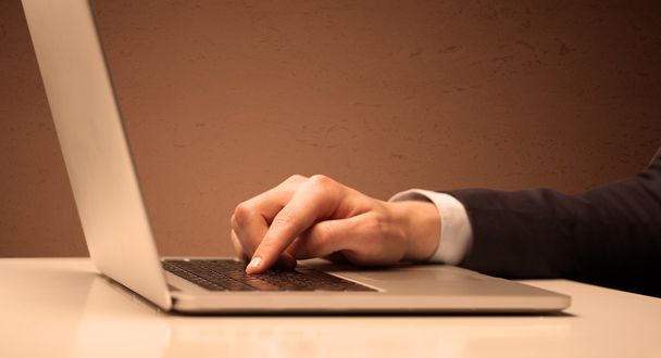 Businessman is suit working on laptop - Фото, изображение
