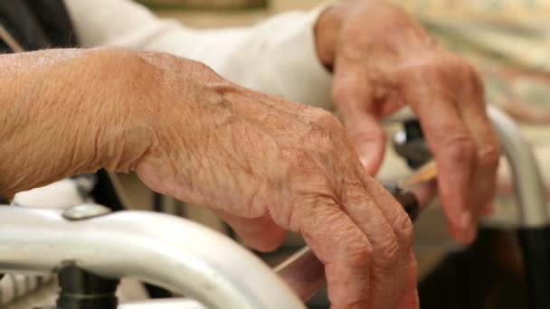 Primer plano de las manos de una anciana sobre una muleta
 - Metraje, vídeo