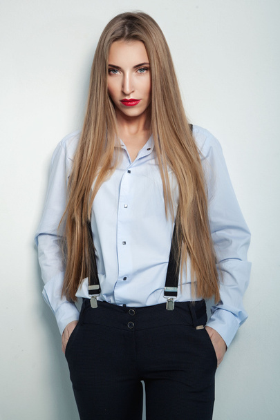 young attractive businesswoman in black pants and blue shirt wit - Foto, Bild