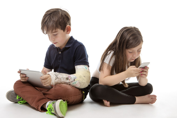 children engrossed in technology - Фото, изображение