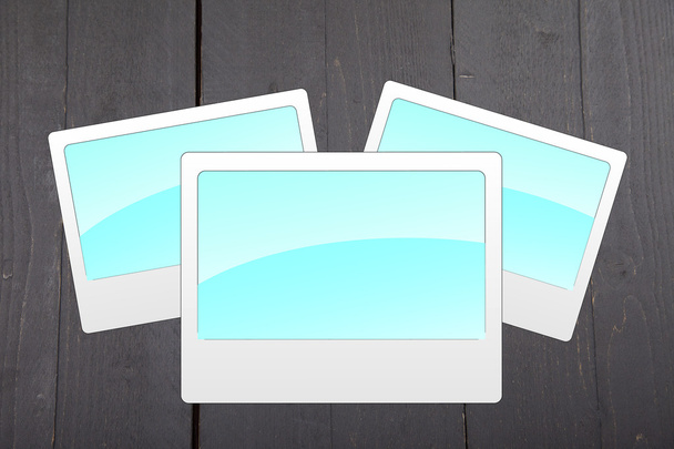 Illustration of empty blue photo frames on dark black wooden background - Photo, Image