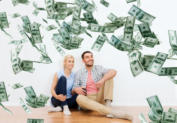 happy couple at home over dollar money falling - Valokuva, kuva