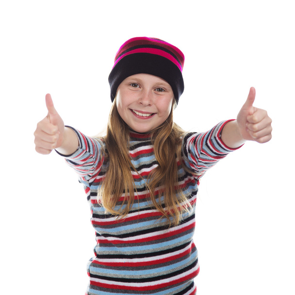 Beautiful girl in colored striped hat and sweater. - Foto, Bild