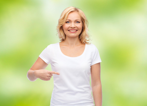 smiling woman in white t-shirt pointing to herself - Photo, image