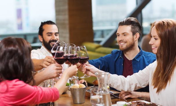 friends dining and drinking wine at restaurant - Φωτογραφία, εικόνα