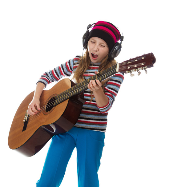The girl in headphones with a guitar. - Foto, Bild