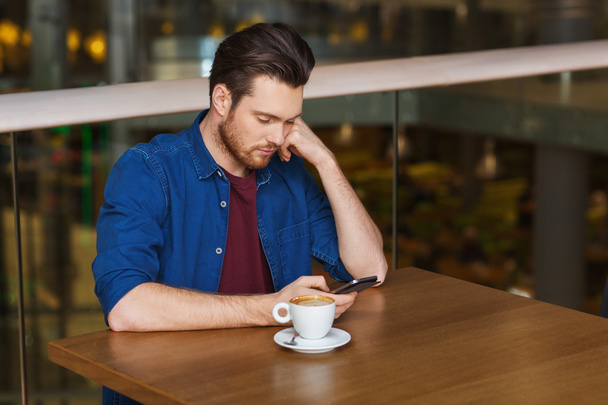 man with smartphone and coffee at restaurant - Photo, Image