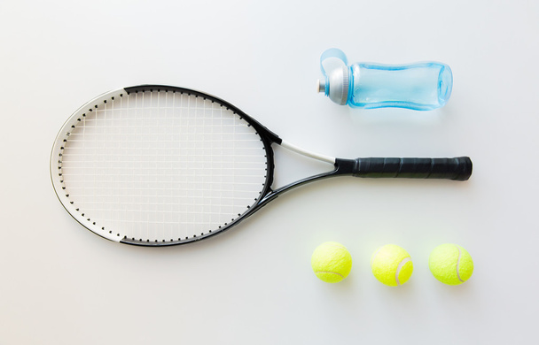 close up of tennis racket with balls and bottle - Foto, Imagem