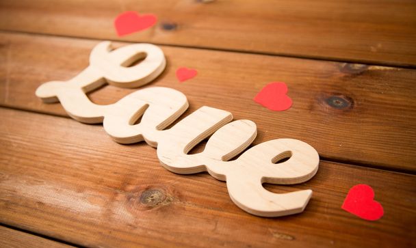 close up of word love with red paper hearts - 写真・画像