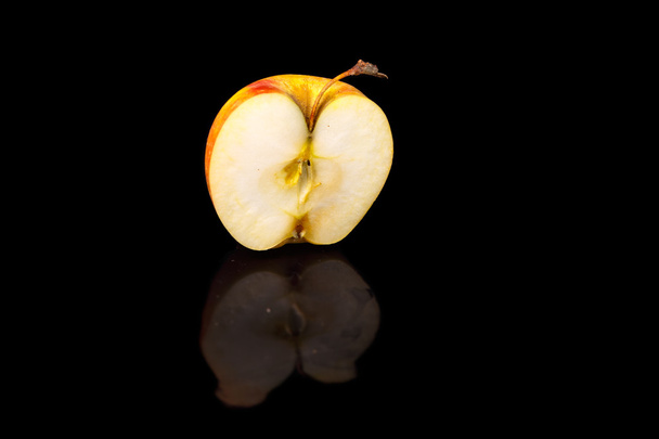 Apples on black wavy mirror. - 写真・画像