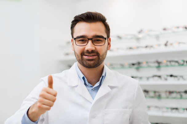 man with glasses and thumbs up at optics store - Фото, зображення