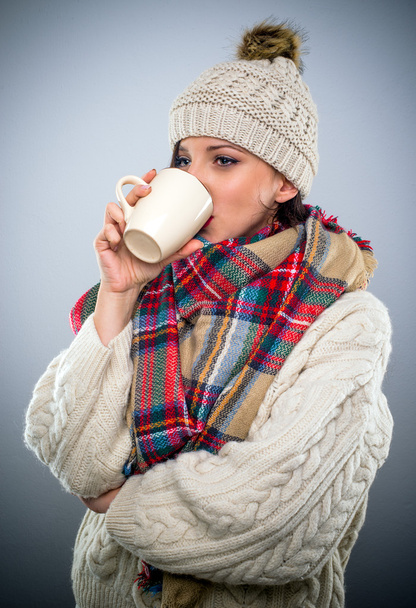Young woman enjoying a mug of hot coffee - Photo, Image