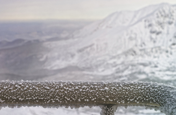 Fragment of a Fence Rail being frozen in mountains in winter - Photo, Image