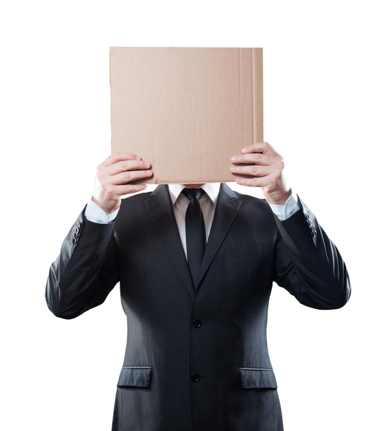 Businessman holding cardboard on white background. Clipping path - Фото, изображение
