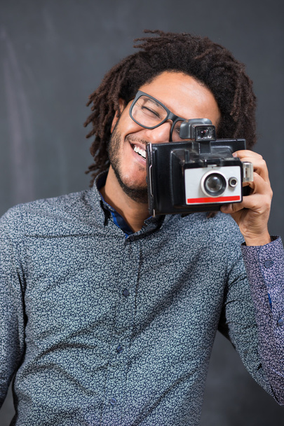 Portrait of a smiling afro american man making photo on retro ca - Foto, immagini