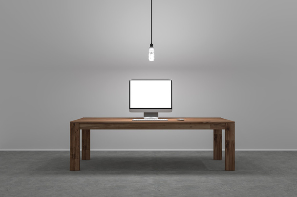 single computer screen on large desk with lamp hangig from ceili - Фото, зображення