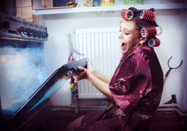Shocked housewife in the kitchen baking something - Φωτογραφία, εικόνα