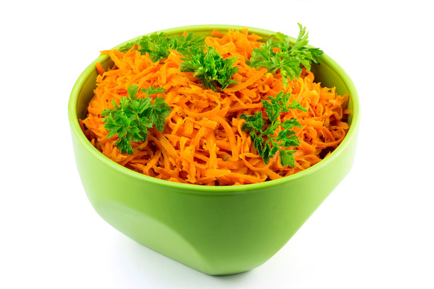 Spicy salad of grated carrots in bowl, isolated on white background - Photo, Image