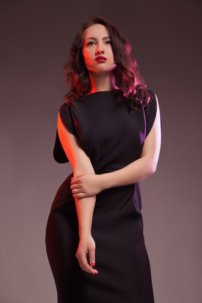 sexy woman in black dress on red blackground - Foto, Imagem