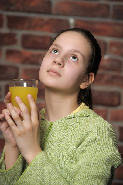 The girl the teenager and orange juice - Valokuva, kuva