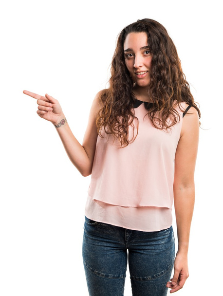 Teenager girl pointing to the lateral - Photo, Image